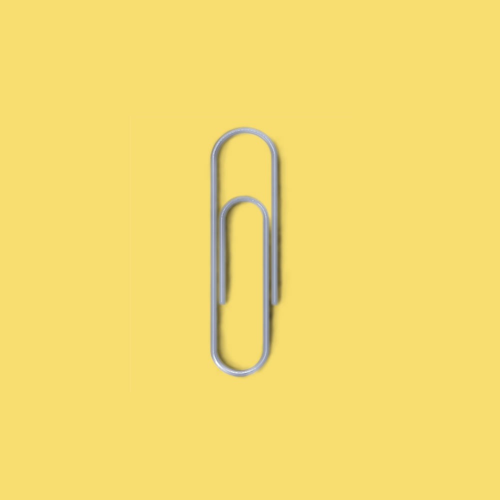 Paper clip on pastel blue background