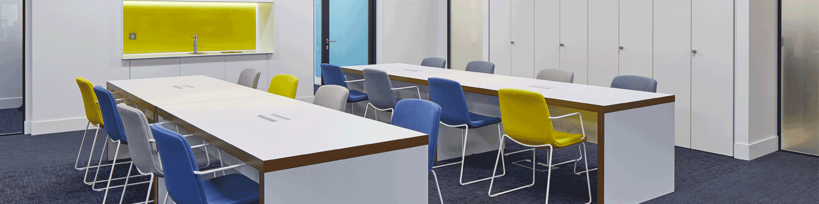 Hampshire Trust Bank's office desks with multi coloured chairs