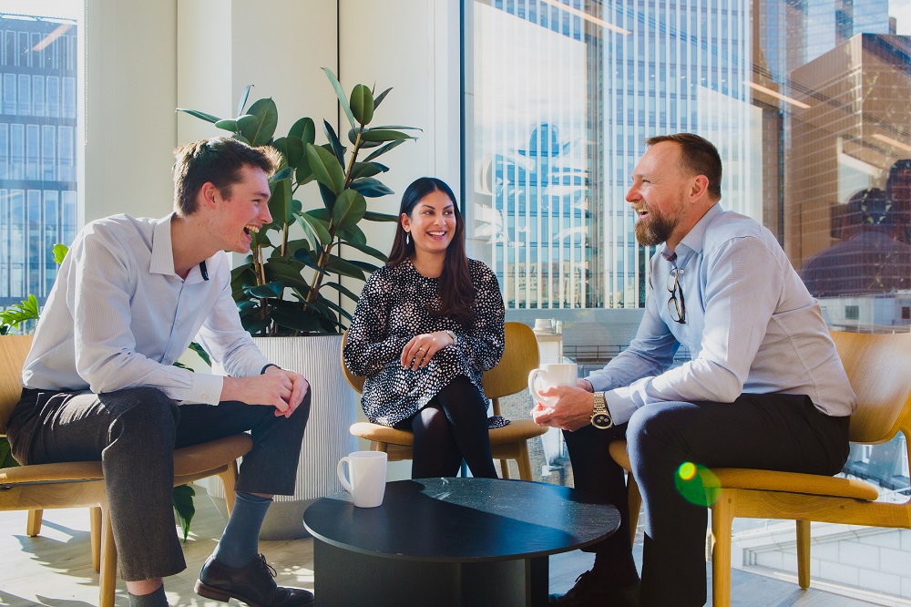 Happy staff sitting around table